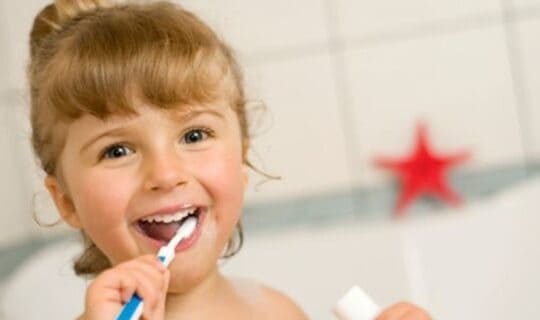 a girl brushing her teeth